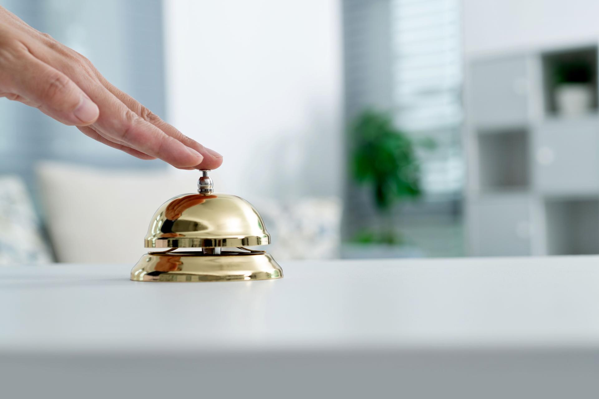Woman hand ringing a service bell