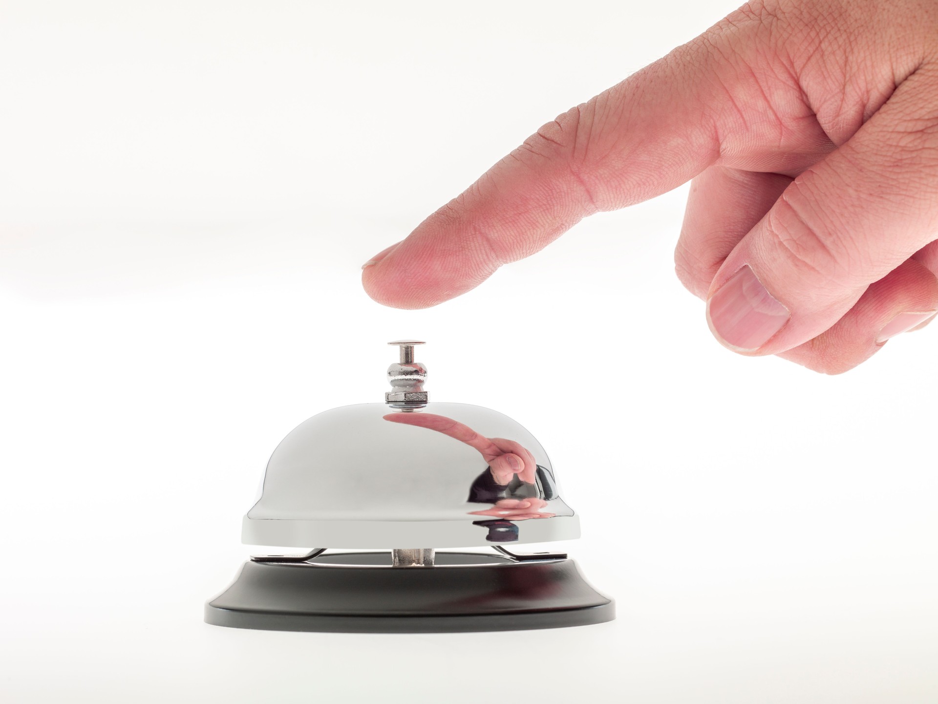 Man hand ringing a reception bell.Studio shot on a white background. No people.